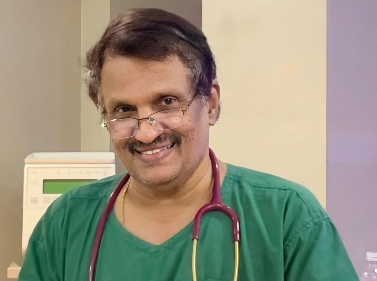 Dr. S. Manohar, Consultant Neonatologist, in green scrubs with a stethoscope